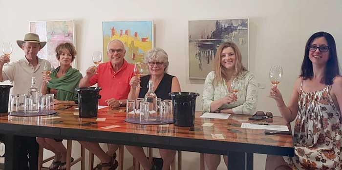 Six people enjoying winetasting